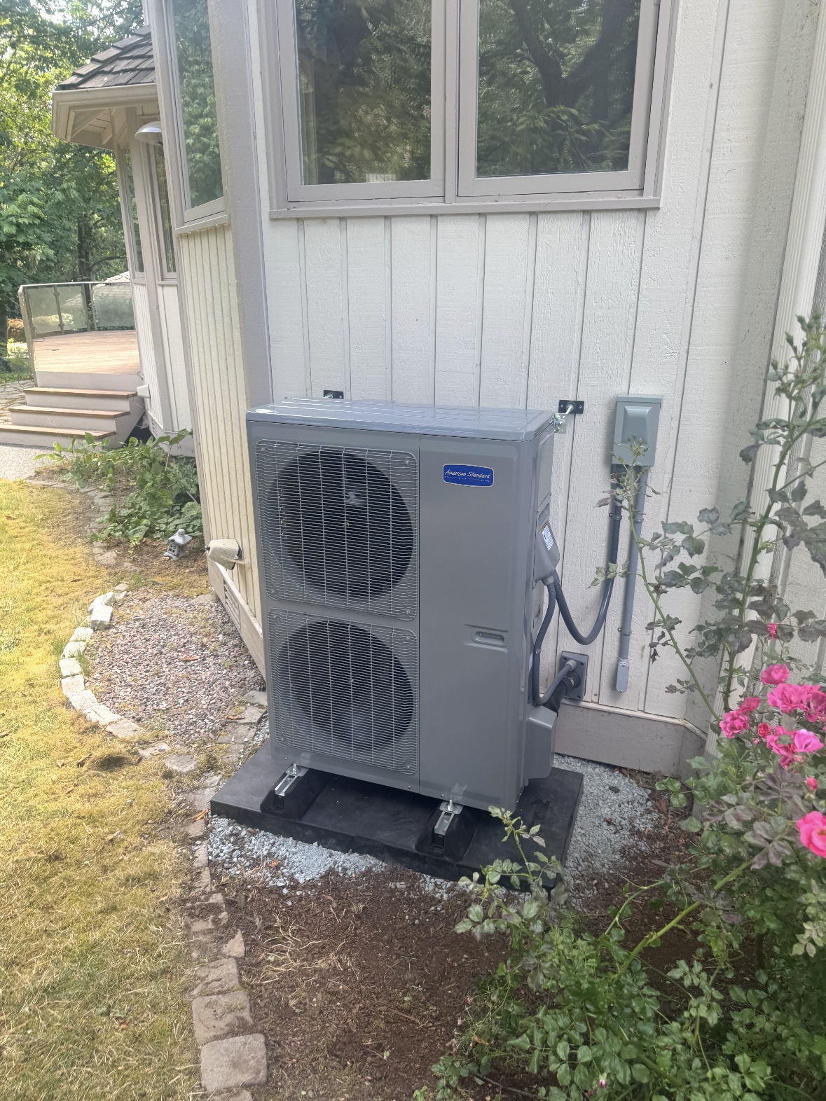 American Standard heat pump condenser installed on a composite pad beside a home in Snohomish County, WA