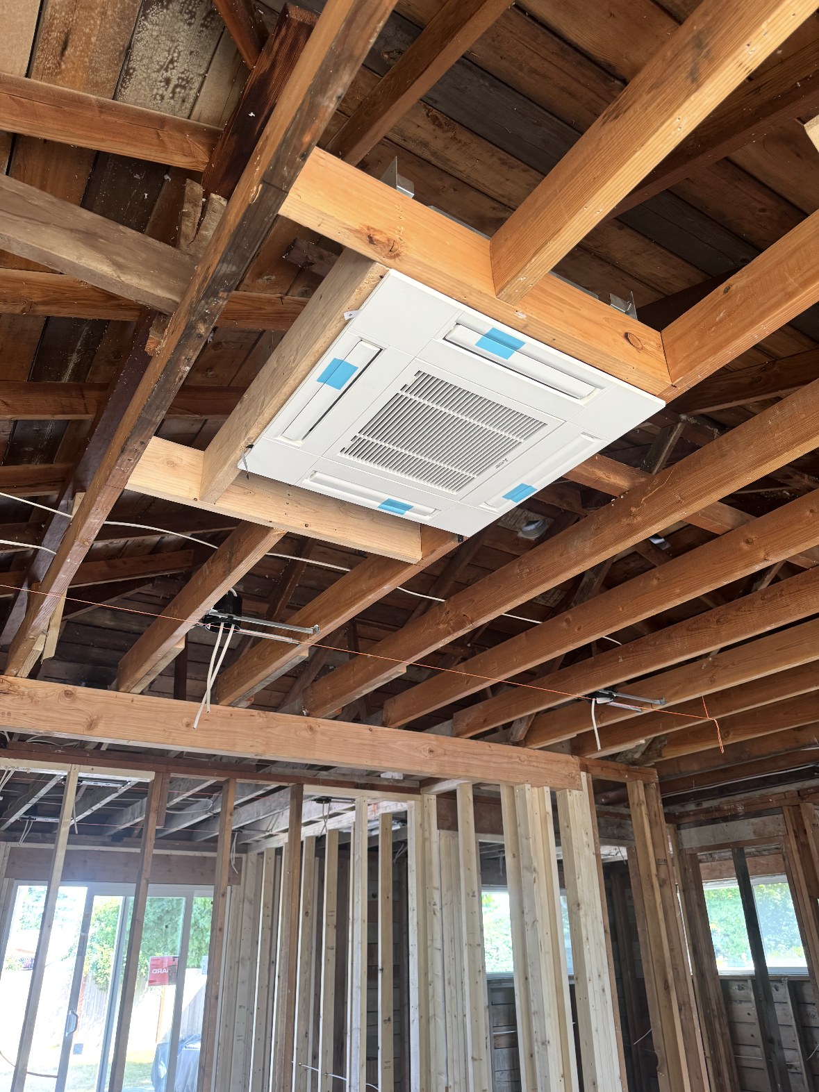 Mitsubishi Electric ceiling cassette indoor unit mounted between ceiling joists during a remodel near Everett, WA